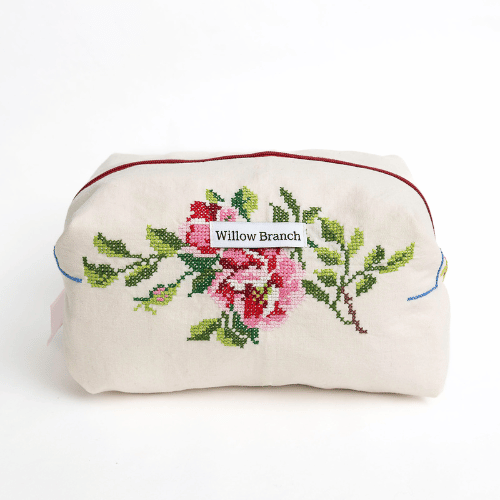 Embroidered pouch with floral design and 'Willow Branch' label on a white background