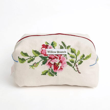Embroidered pouch with floral design and 'Willow Branch' label on a white background