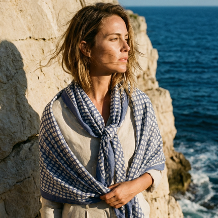 Blue lightweight cotton block print scarf worn by model coastal setting / Foulard léger en coton bleu imprimé bloc porté en bord de mer