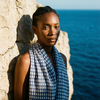 Blue lightweight cotton block print scarf worn by model coastal setting / Foulard léger en coton bleu imprimé bloc porté en bord de mer