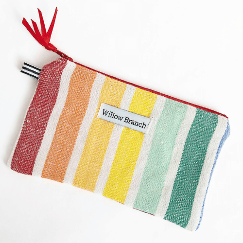 Handmade rainbow stripe flat zipper pouch with red tassel pull, Montreal artisan Willow Branch / Pochette plate zippée rayures arc-en-ciel avec tirette à pompons rouge, artisane montréalaise Willow Branch