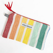 Handmade rainbow stripe flat zipper pouch with red tassel pull, Montreal artisan Willow Branch / Pochette plate zippée rayures arc-en-ciel avec tirette à pompons rouge, artisane montréalaise Willow Branch