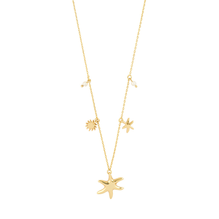 Gold plated cable chain necklace with large starfish pendant, small starfish charm, sun charm, and two freshwater pearl accents on white background. Gold plated cable chain necklace with large starfish pendant, small starfish charm, sun charm, and two freshwater pearl accents on white background
